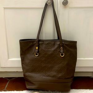 Louis Vuitton brown embossed leather bucket bag. Measures 11in X 14 in.